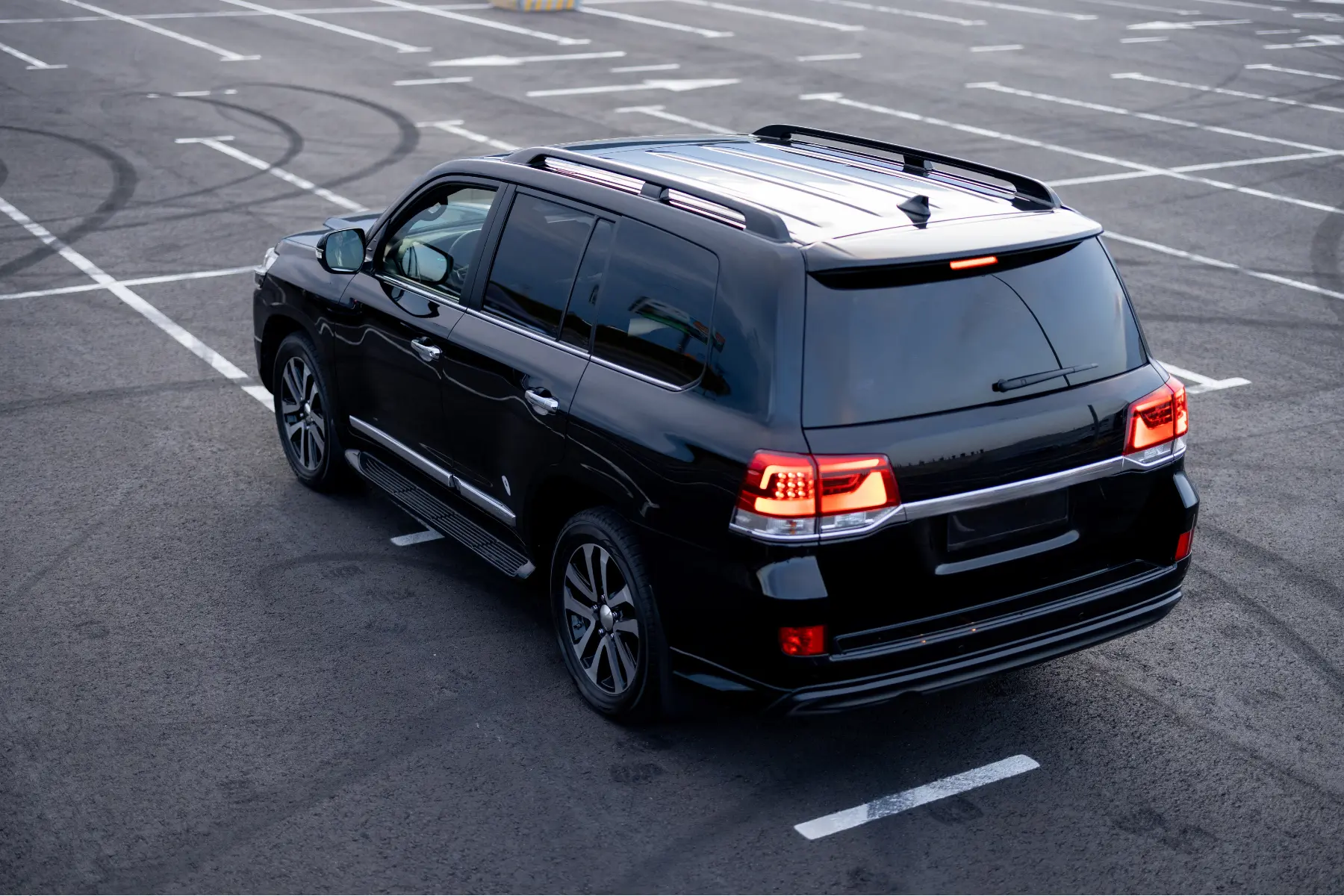 Best 2025 SUV featuring a sleek black design, tinted windows, and modern taillights, parked in an open lot.