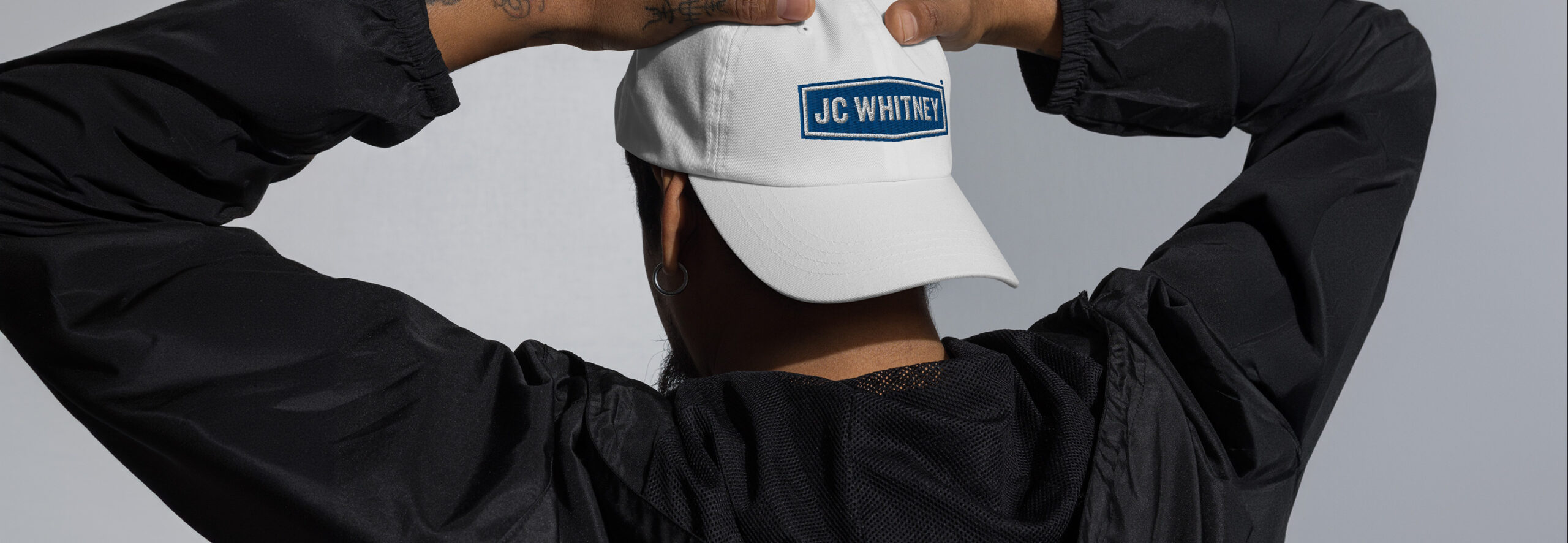 Man wearing JC Whitney hat