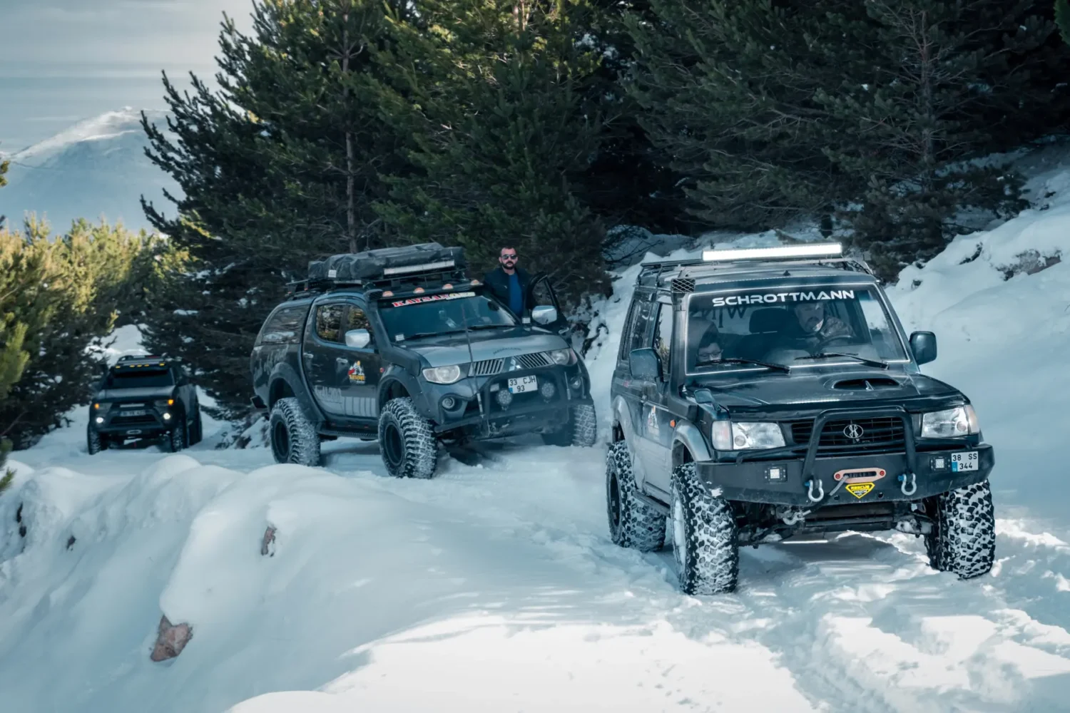 pickup truck lift - JC Whitney Pickup truck lift helps a convoy of lifted off-road trucks tackle deep snow on a rugged winter trail.