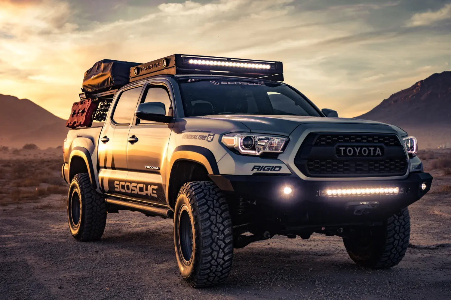 shocks for trucks - JC Whitney Shocks for trucks visible on an off-road Toyota Tacoma equipped for desert terrain.