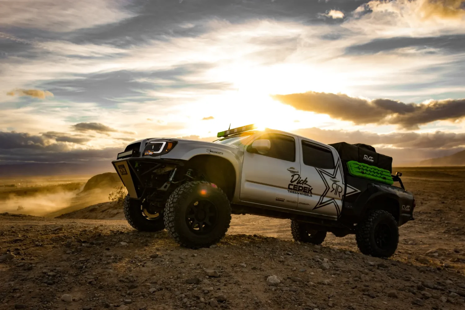 truck suspension upgrades - JC Whitney Truck suspension upgrades featured on a lifted off-road truck at sunset in the desert.
