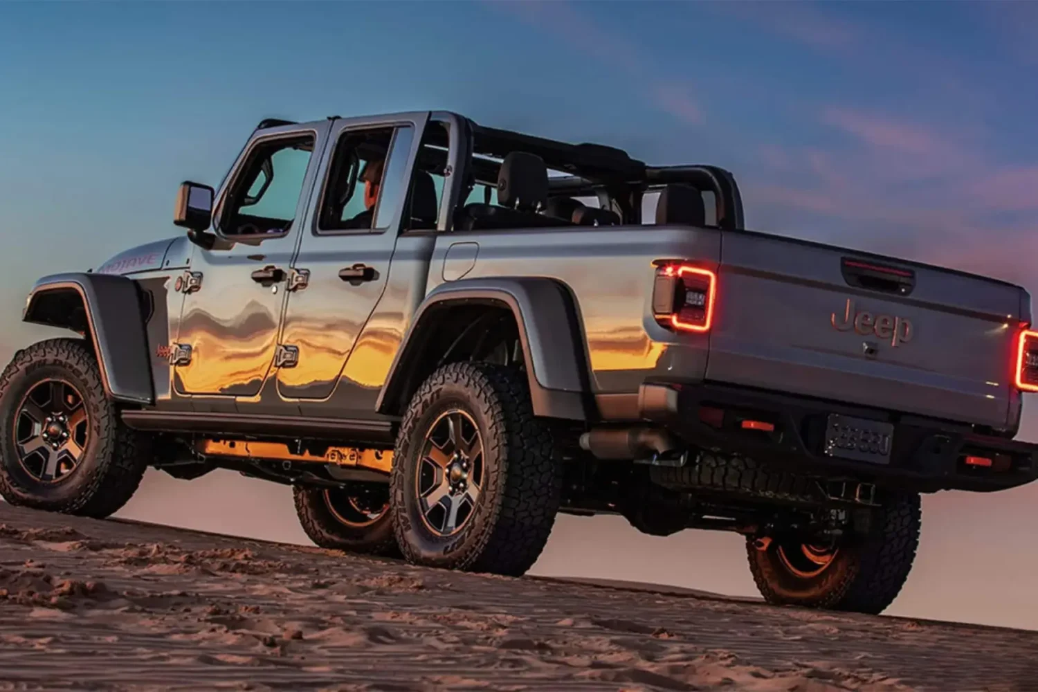 Jeep Gladiator Accessories - JC Whitney Jeep Gladiator accessories include rugged wheels and tube doors showcased during a sunset desert drive.